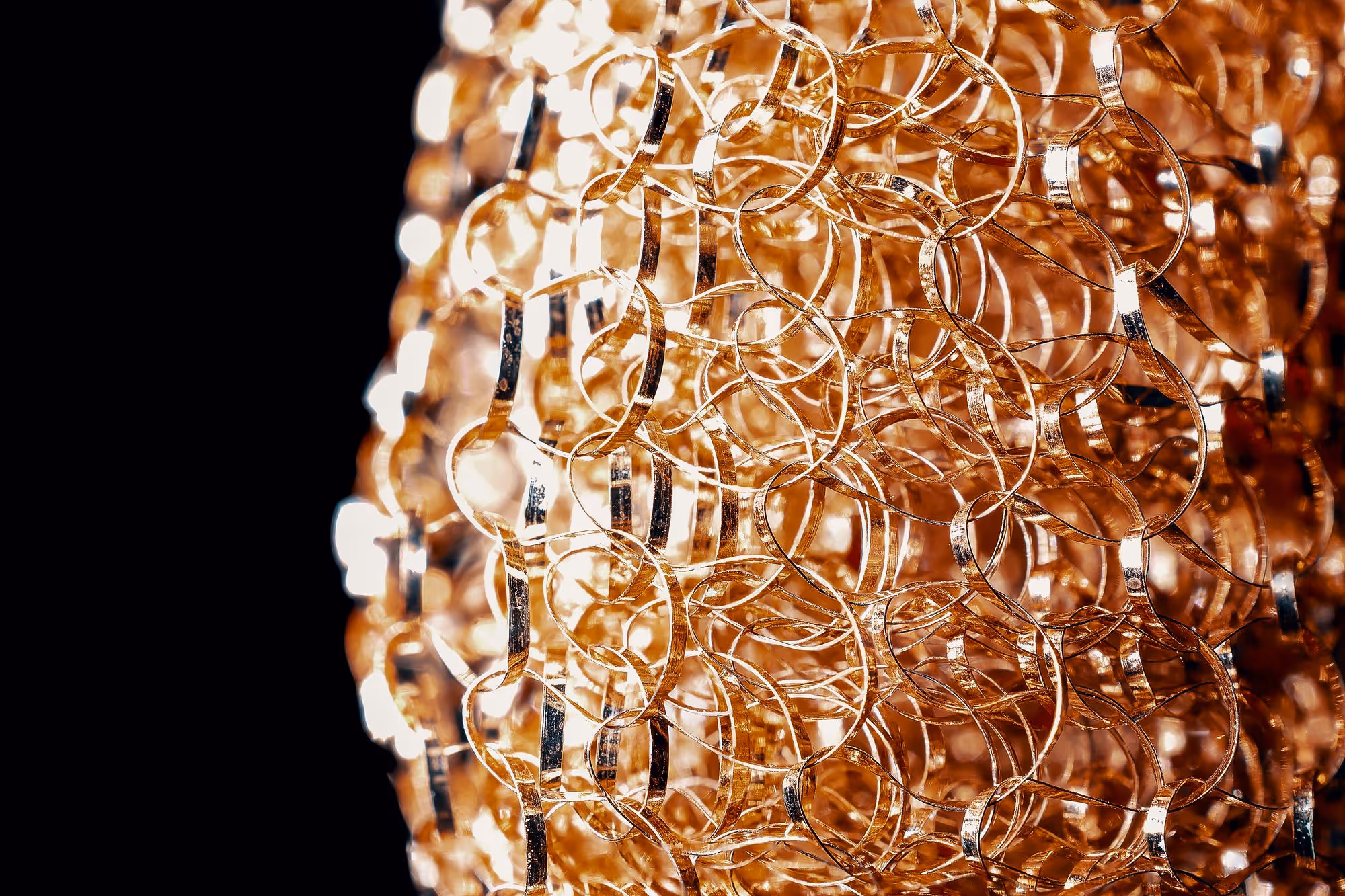 Macro of interlocking gold links catching the light